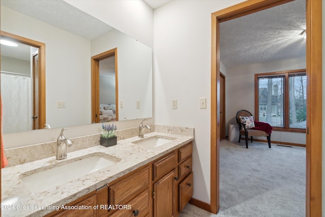 bathroom with a textured ceiling and vanity