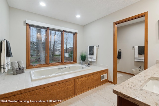 bathroom featuring tile patterned flooring, a bathtub, sink, and a bidet