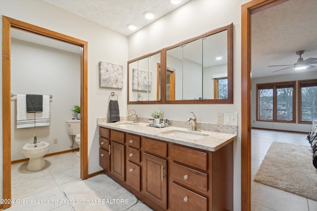 bathroom featuring vanity, a textured ceiling, ceiling fan, a bidet, and tile patterned flooring