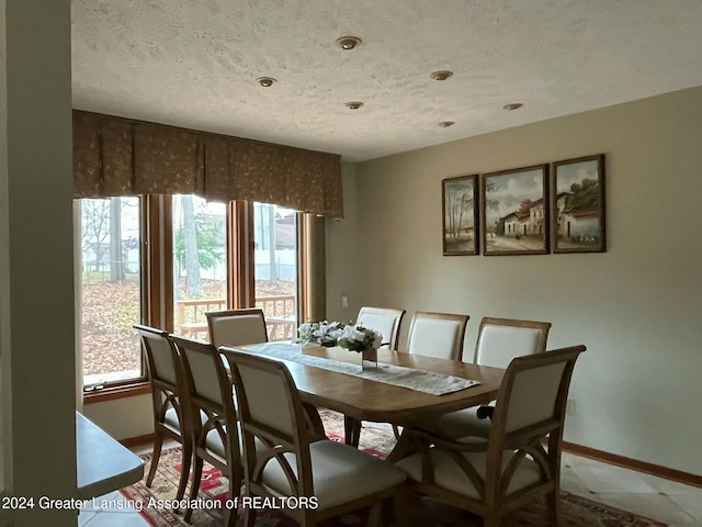 dining area featuring a textured ceiling