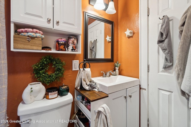 bathroom featuring vanity and toilet