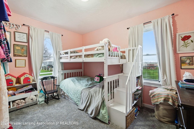 carpeted bedroom featuring multiple windows