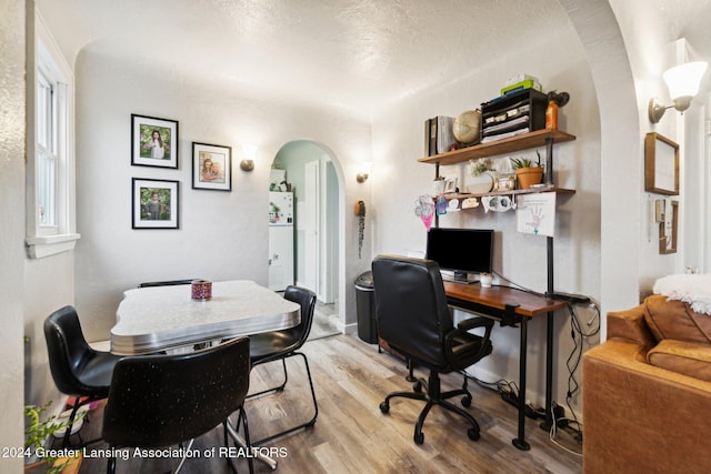 office featuring a textured ceiling and light hardwood / wood-style flooring