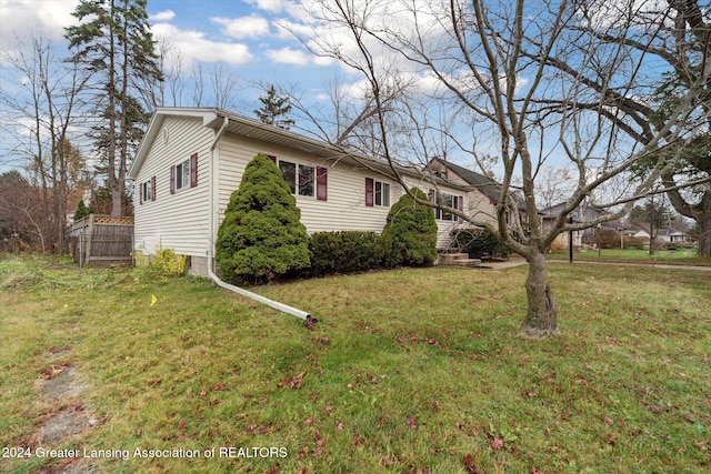 view of side of property with a lawn