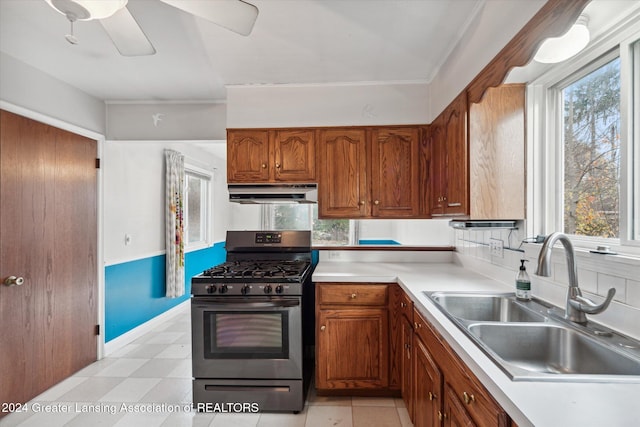 kitchen with ceiling fan, gas stove, and sink