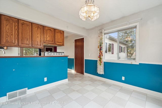 kitchen featuring decorative light fixtures and an inviting chandelier