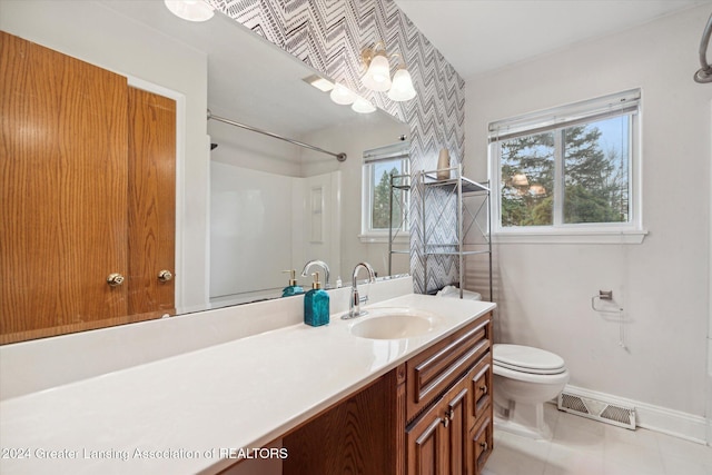 bathroom with tile patterned flooring, vanity, and toilet