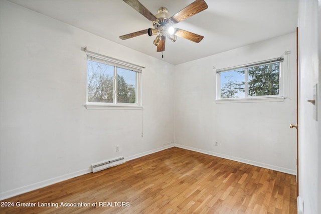 spare room with light wood-type flooring, a baseboard radiator, and ceiling fan