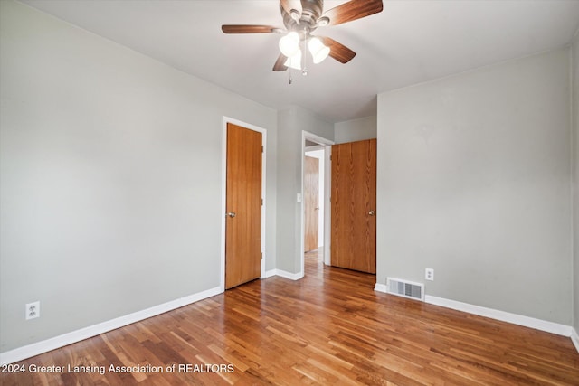 empty room featuring ceiling fan and light wood-type flooring