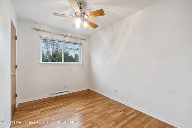 spare room with light wood-type flooring, a baseboard radiator, and ceiling fan