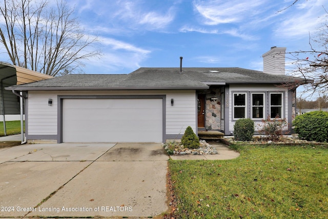 ranch-style home with a front yard and a garage