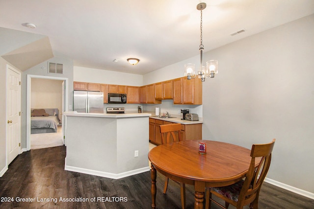 kitchen featuring hanging light fixtures, stainless steel appliances, dark hardwood / wood-style floors, and a notable chandelier