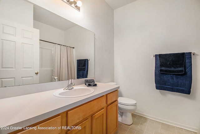 bathroom with walk in shower, vanity, and toilet