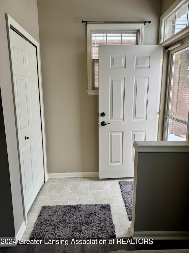 doorway to outside with light tile patterned floors