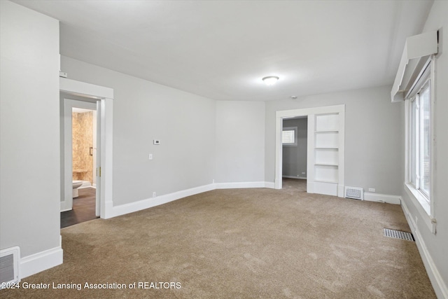 unfurnished bedroom featuring carpet, connected bathroom, and a closet