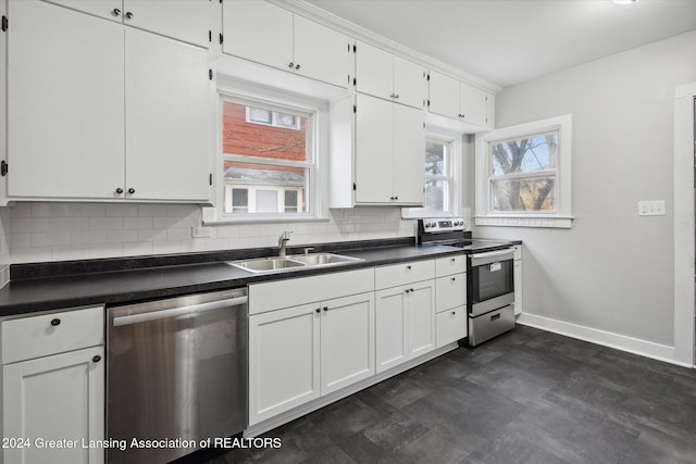 kitchen with tasteful backsplash, sink, white cabinets, and appliances with stainless steel finishes