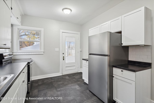 kitchen featuring appliances with stainless steel finishes, tasteful backsplash, and white cabinetry