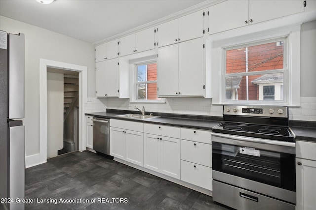 kitchen with tasteful backsplash, sink, white cabinets, and stainless steel appliances