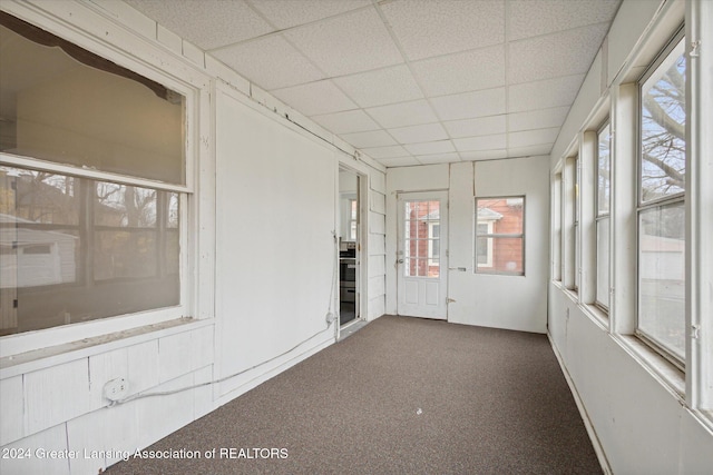 unfurnished sunroom featuring a drop ceiling