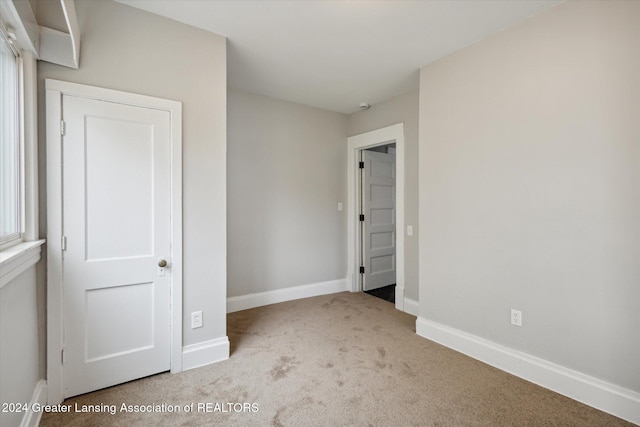 unfurnished bedroom with light colored carpet