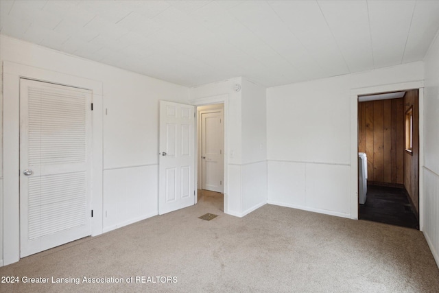 unfurnished bedroom featuring carpet flooring and a closet