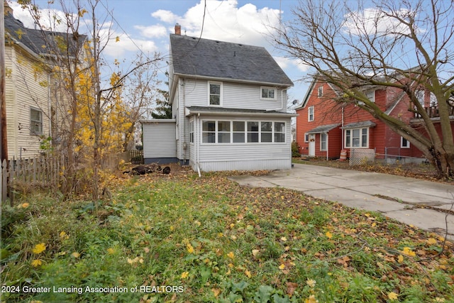 back of house with a sunroom