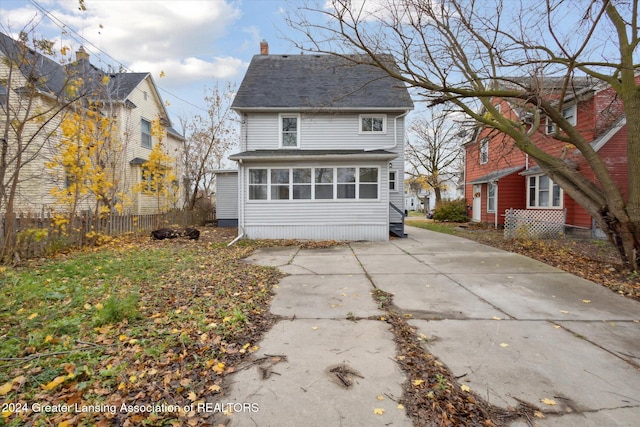 back of property with a sunroom