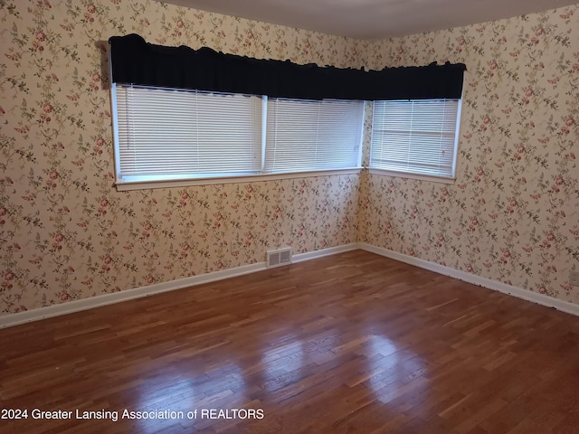 unfurnished room featuring hardwood / wood-style flooring