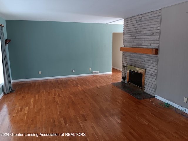 unfurnished living room featuring a fireplace and hardwood / wood-style floors