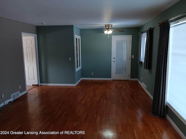 unfurnished room featuring ceiling fan and dark hardwood / wood-style flooring