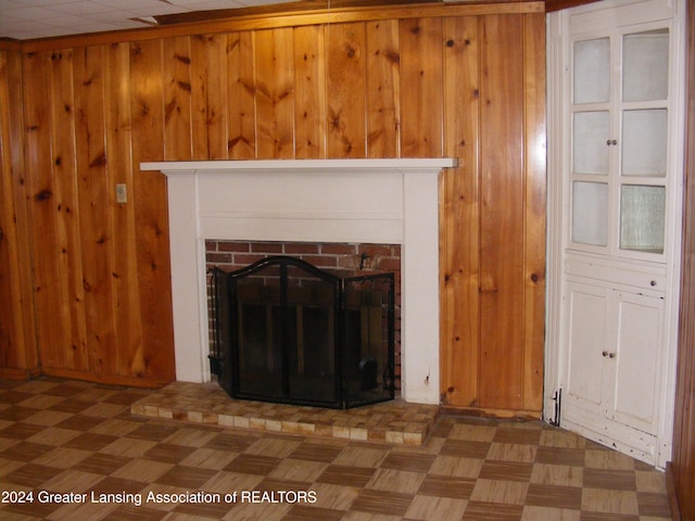 details with wooden walls, parquet floors, and a brick fireplace