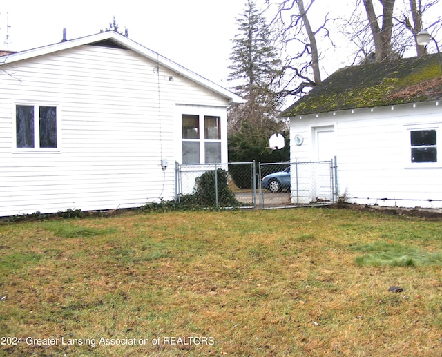 view of side of home with a lawn