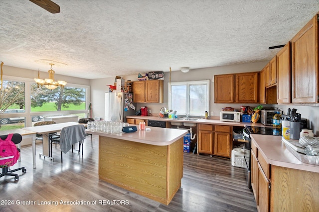 kitchen featuring pendant lighting, dark hardwood / wood-style floors, stainless steel appliances, and a wealth of natural light