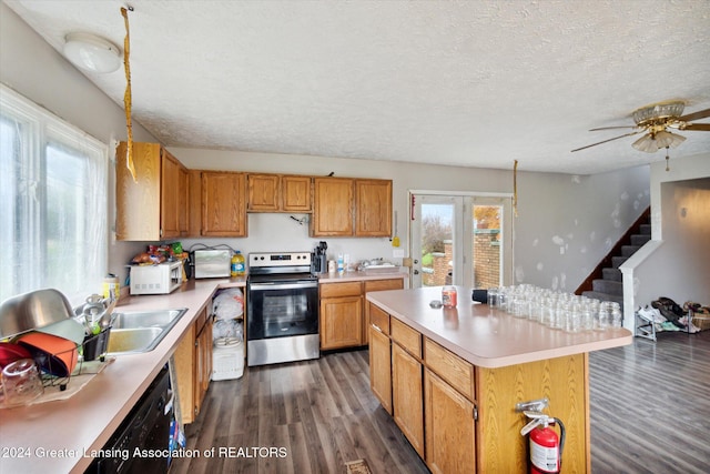 kitchen featuring electric range, a kitchen island, dark wood-type flooring, and a textured ceiling