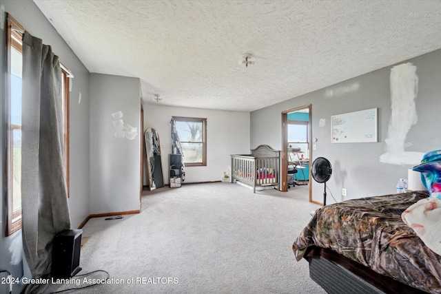 carpeted bedroom featuring a textured ceiling