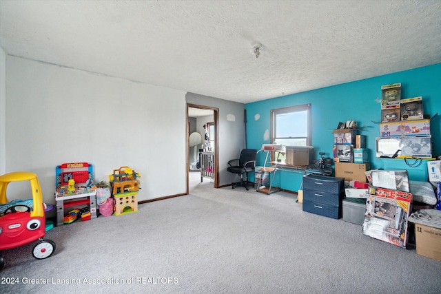 rec room with carpet and a textured ceiling