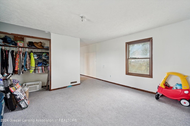 bedroom featuring carpet flooring, a textured ceiling, and a closet