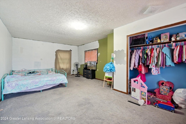 bedroom featuring carpet flooring, a closet, and a textured ceiling