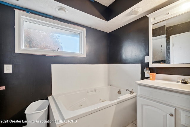 bathroom with vanity and a tub to relax in