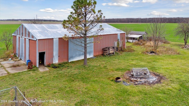 view of outdoor structure with a yard and a rural view