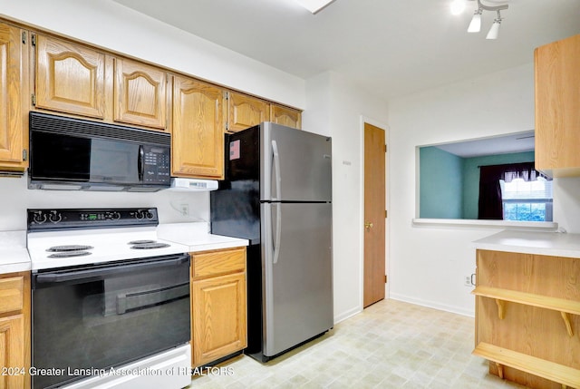 kitchen featuring white range with electric stovetop and stainless steel fridge