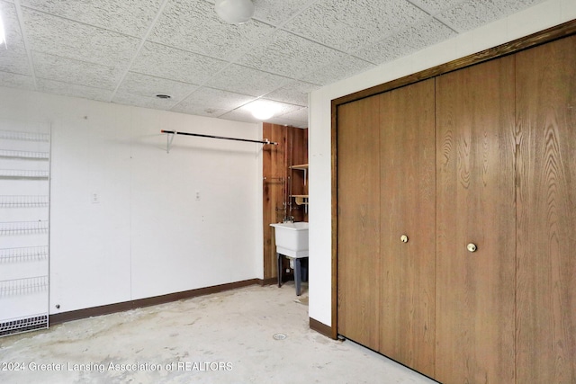 unfurnished bedroom featuring a drop ceiling