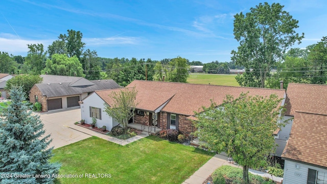 view of front of house featuring a front lawn, a porch, and a garage