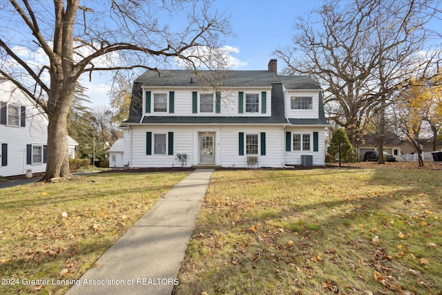 view of front of home featuring central air condition unit and a front lawn