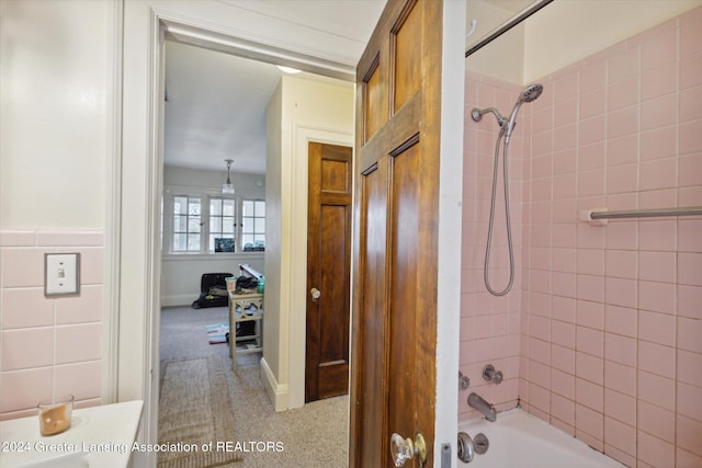 bathroom with vanity and tiled shower / bath combo