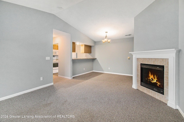 unfurnished living room with a chandelier, carpet floors, a fireplace, and vaulted ceiling