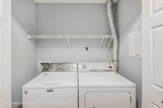 washroom with washing machine and clothes dryer