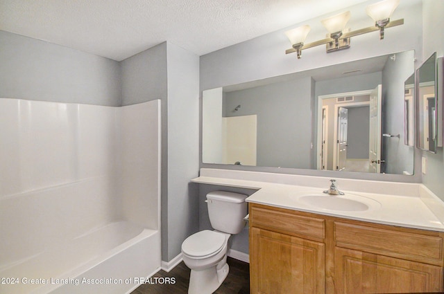 full bathroom with hardwood / wood-style floors, vanity, toilet, a textured ceiling, and shower / bathtub combination