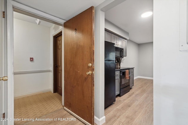 kitchen with black appliances and light wood-type flooring