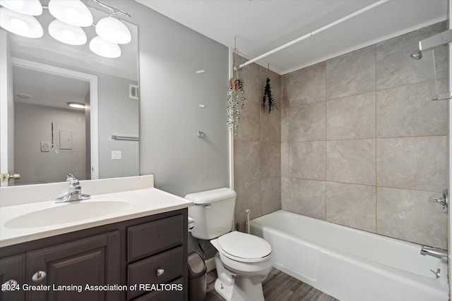 full bathroom featuring vanity, toilet, and tiled shower / bath combo